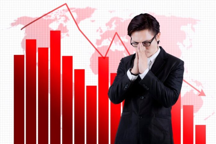 sad-businessman-standing-near-declining-graph_175634-32942